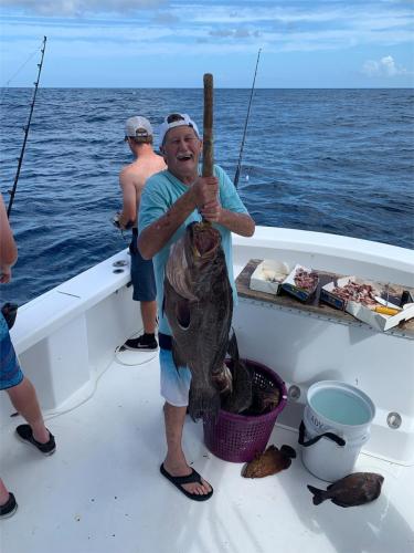 Group with their catch at the dock