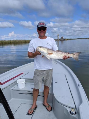 Group photo with a day's catch at the dock