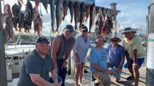 A charter group with a full rack of fish on the dock